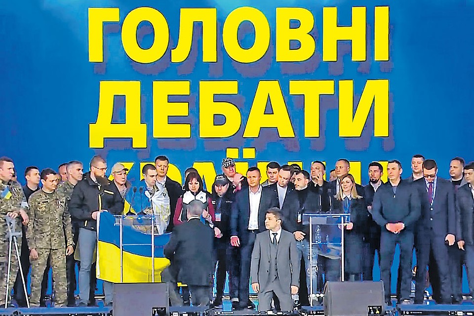 Главный спор кандидатов в президенты Украины Владимира Зеленского и Петра Порошенко превратился в цирк со вставанием на колени и традиционным обвинением России. Фото: youtube.com/RT
