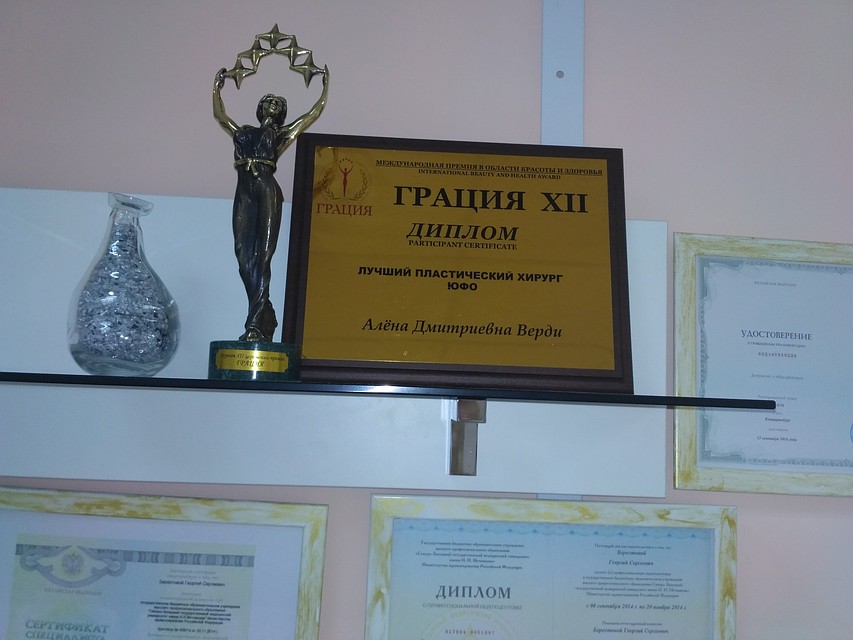 Стены врача украшали десятки дипломов и наград.