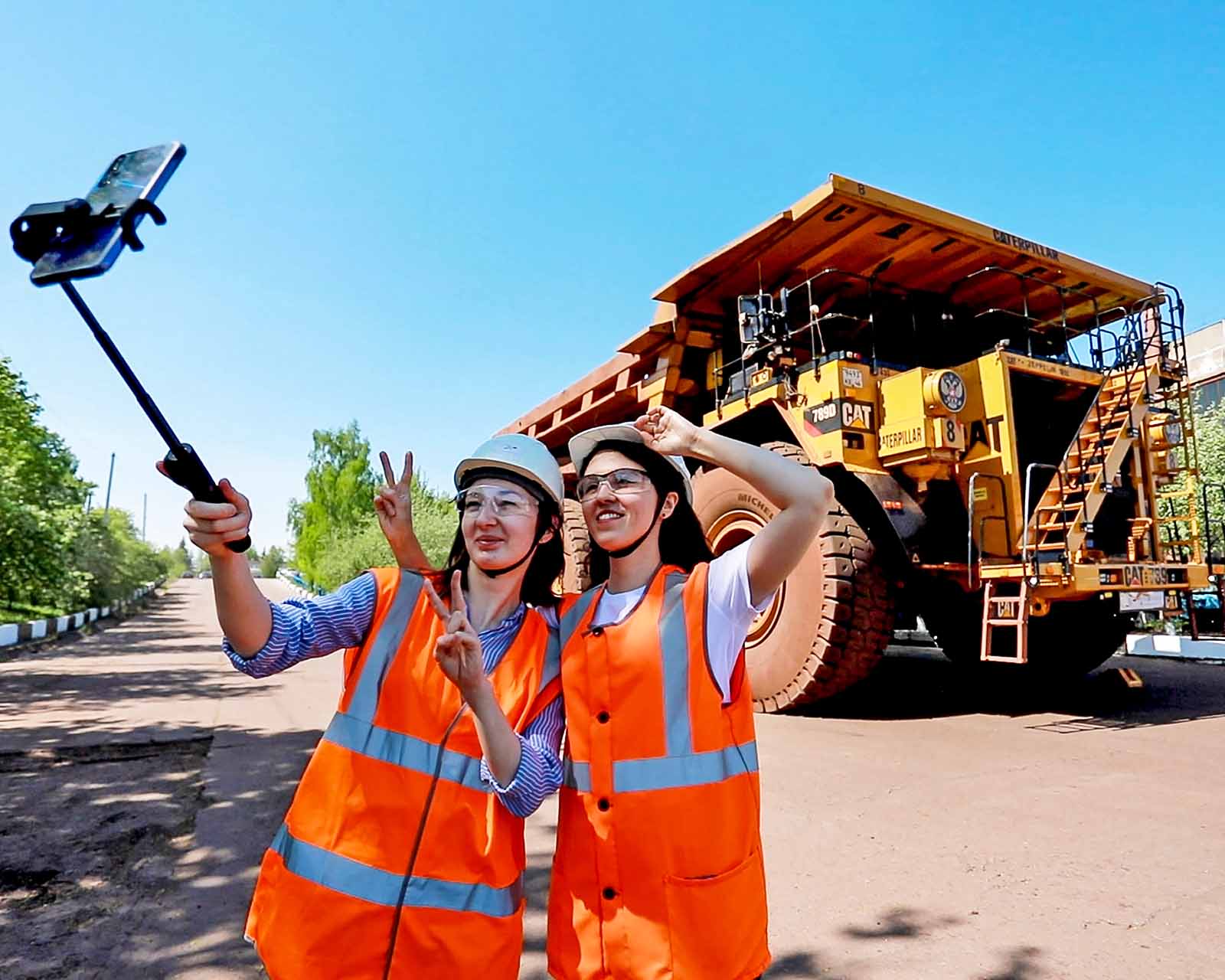 девушки делают селфи у самосвала