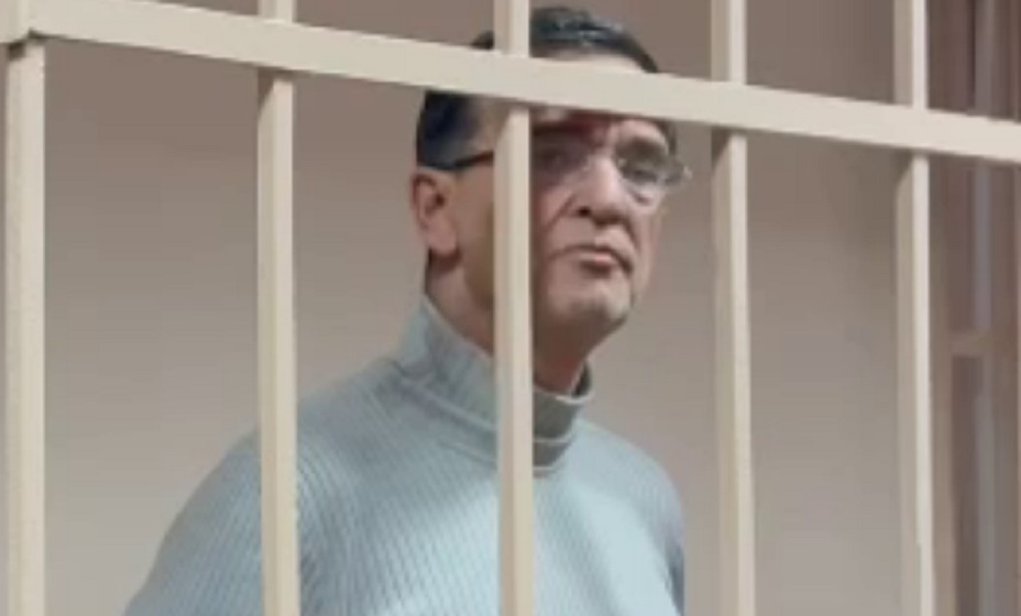 Focus on woman with pony tail. Three young fit women training in gym with a female trainer. Women wearing black sportwears.